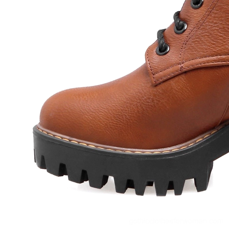 Gothic ankle boots close-up of buckle strap and lacing system - hardware and fastening details