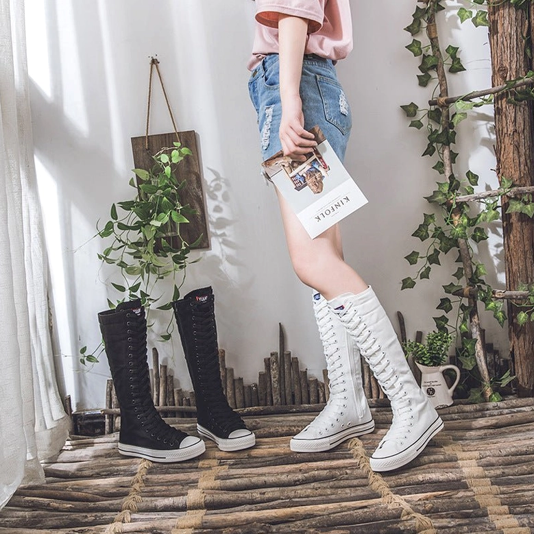 High-top canvas boots detailed construction showing lacing system and canvas quality