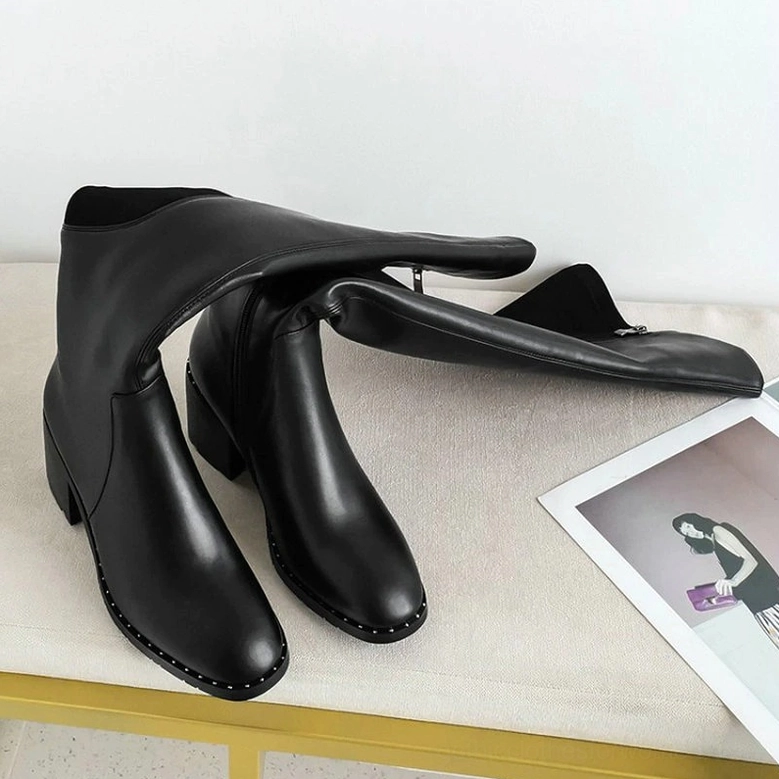 Overhead and detailed view of black leather over-the-knee boots highlighting genuine cow leather quality and construction