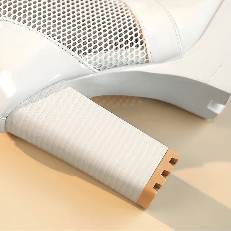 White platform boots heel close-up showing striped block heel design and rubber sole construction