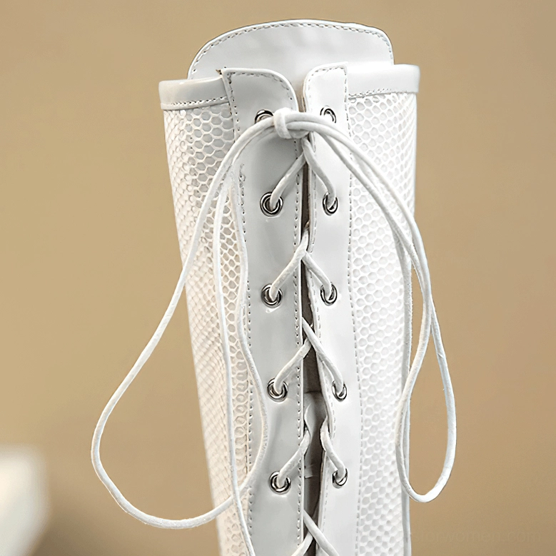 Rear view of white gothic knee-high boots showing lace-up metal eyelets and mesh back panel design