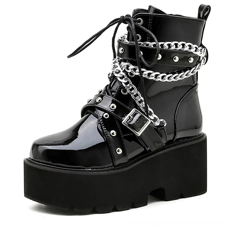 Black patent leather gothic boots three-quarter side view showing lace-up closure and architectural square heel