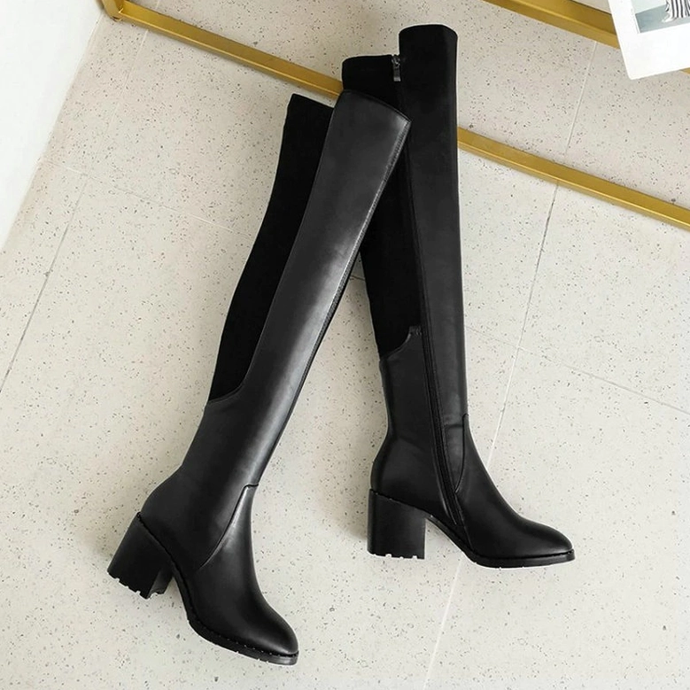 Detailed view of black genuine leather over-the-knee boots showing craftsmanship and texture of cow leather construction