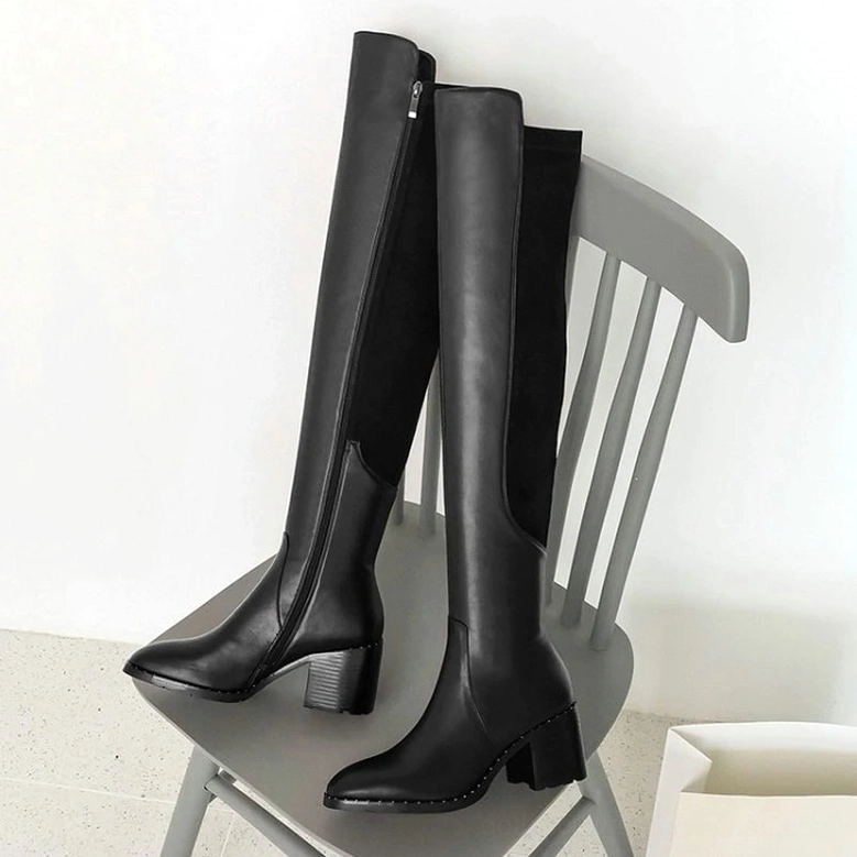 Product photography of black leather over-the-knee gothic boots showing smooth leather finish and professional craftsmanship