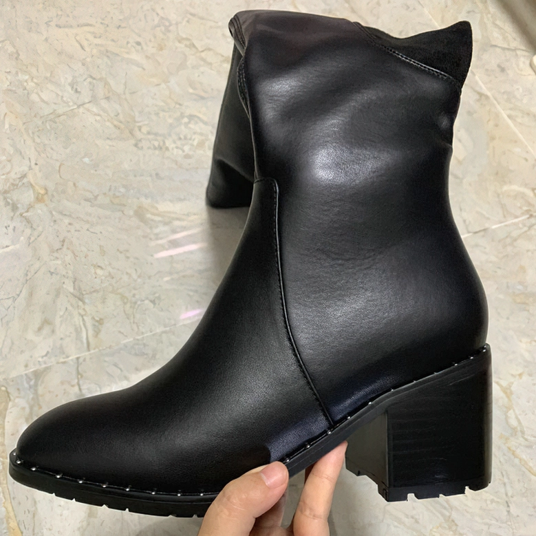 Full length view of black genuine leather over-the-knee gothic boots demonstrating tall silhouette and block heel design