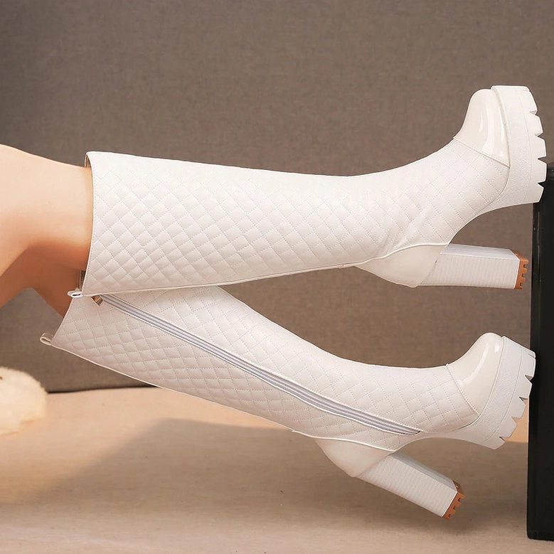 Patent leather toe cap and platform sole detail of gothic quilted boots