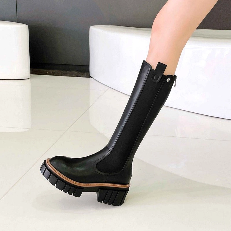Gothic platform boots close-up showing brown trimmed lug sole, pull tab detail and square heel construction