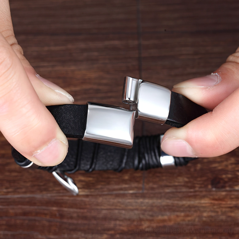 Close-up of magnetic clasp mechanism on gothic bracelet with fingers demonstrating how to unlock and remove