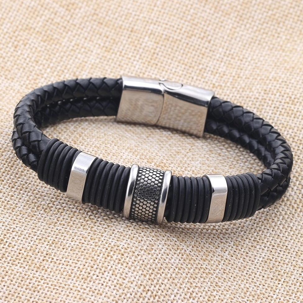 Textured stainless steel decorative ring on black braided leather gothic bracelet