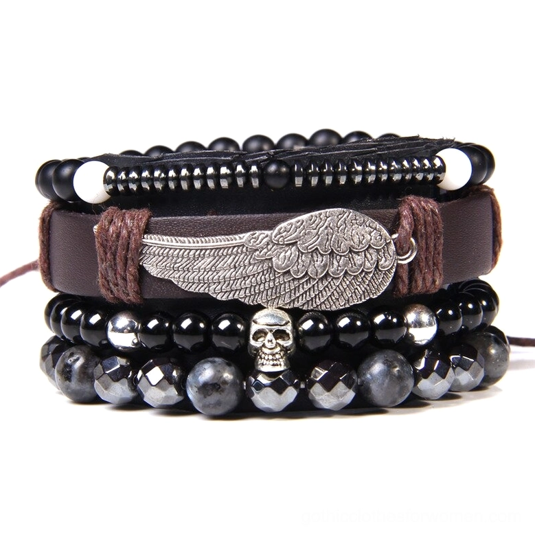 Gothic skull wing charm bracelet stack with faceted black beads and brown leather straps, dark aesthetic jewelry set