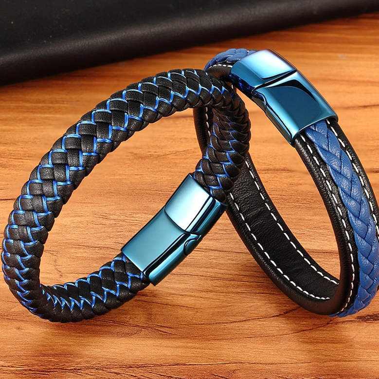 Two gothic leather bracelets styled together on wooden surface, woven and smooth finishes