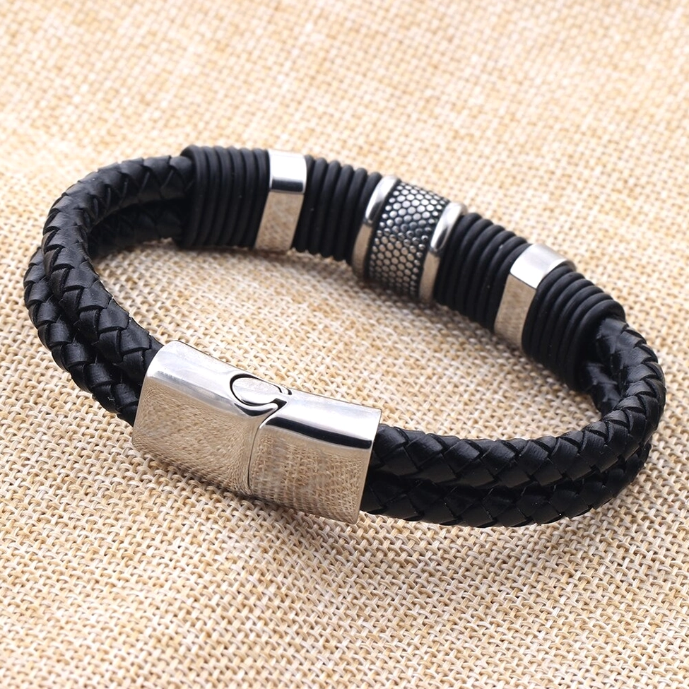 Black woven leather gothic bracelet with polished stainless steel clasp on linen background