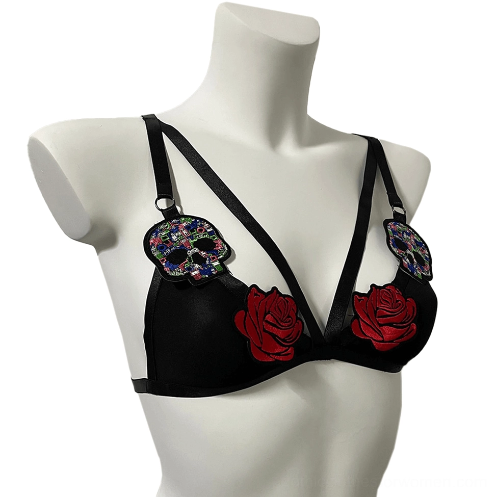 Black gothic triangle bralette with red rose appliques and sugar skull decorations, three-quarter right front angle on white background