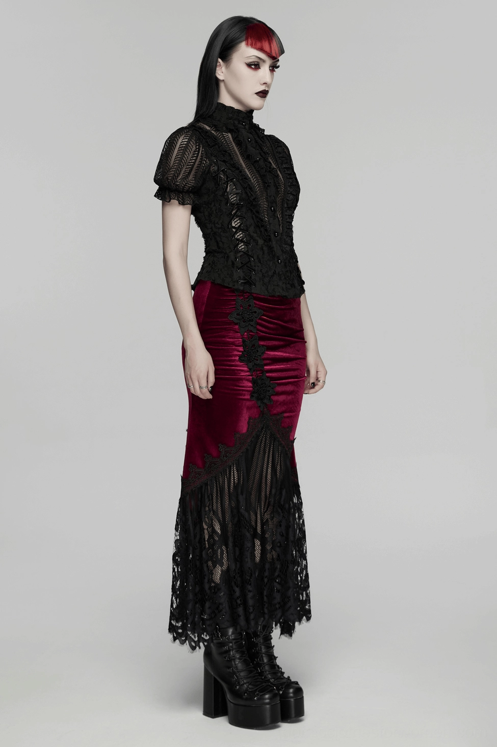 Black gothic lace-up blouse with bubble sleeves worn by model from front angle
