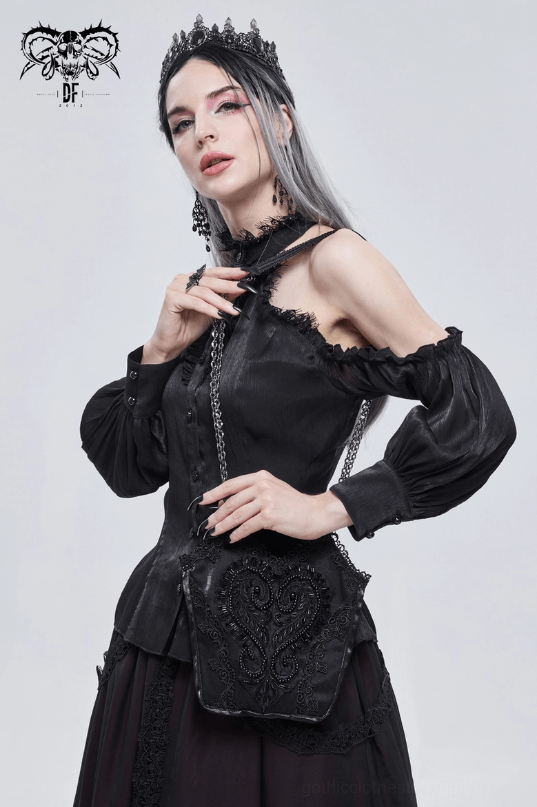 Front styling of black gothic bucket bag worn at hip with off-shoulder blouse and crown accessory