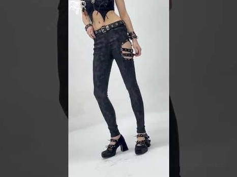 Partial front shot of black gothic buckle pants with platform heels detail