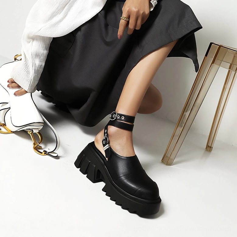 Black gothic buckle sandals on model - side view showing adjustable ankle strap and platform construction