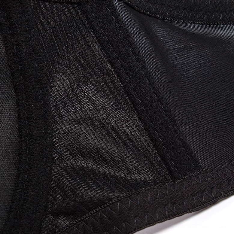 Fabric texture close-up of black mesh and satin spiked angel wings bustier with reinforced stitching