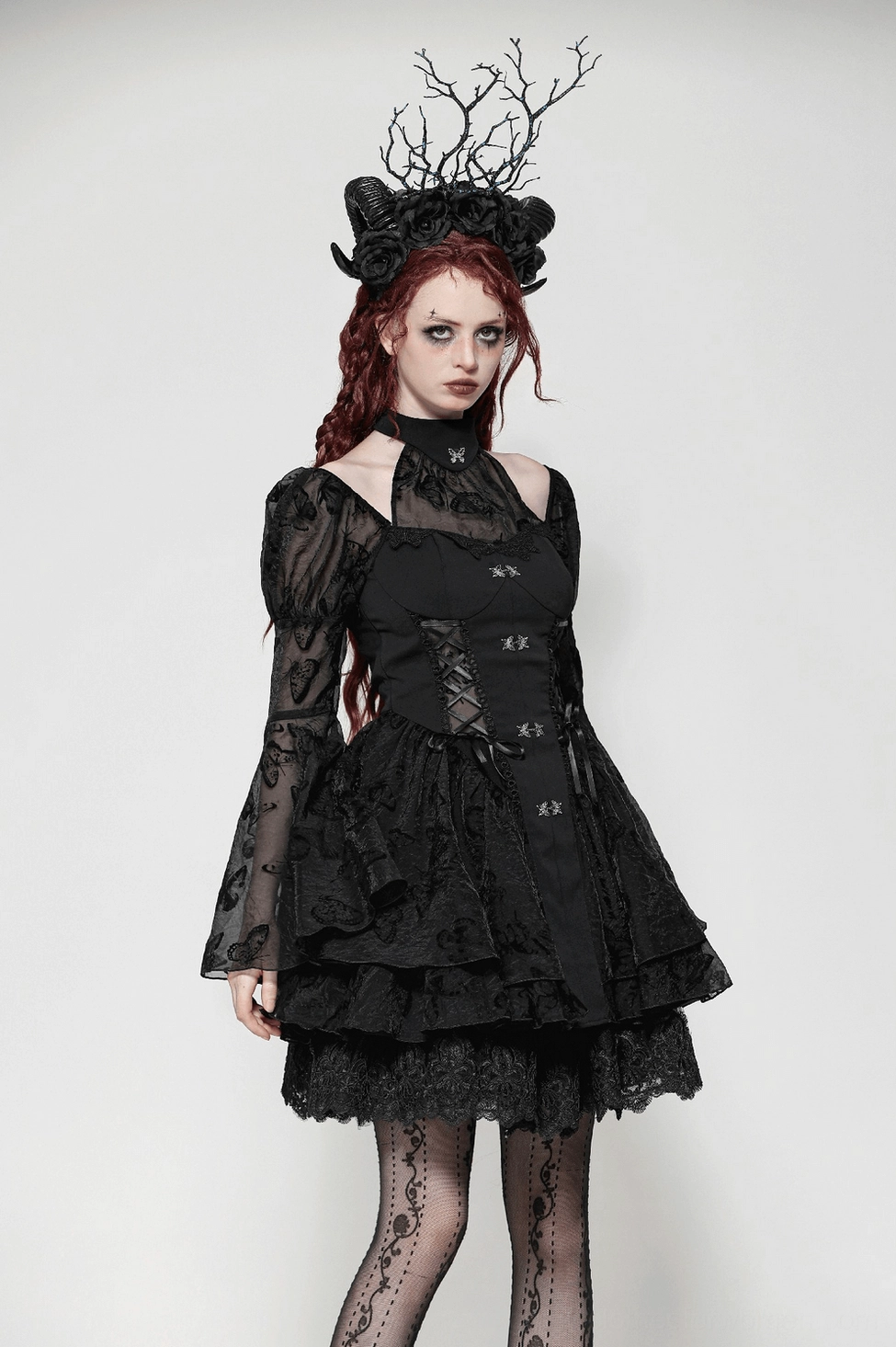 Close-up detail of black gothic butterfly lolita dress showcasing fabric texture and butterfly embroidery
