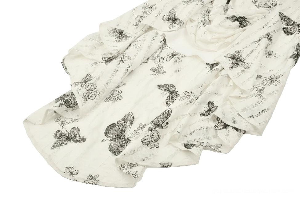 Detailed view of gothic butterfly dress asymmetric high-low hemline with ruffled edge and sketch-style butterfly print pattern
