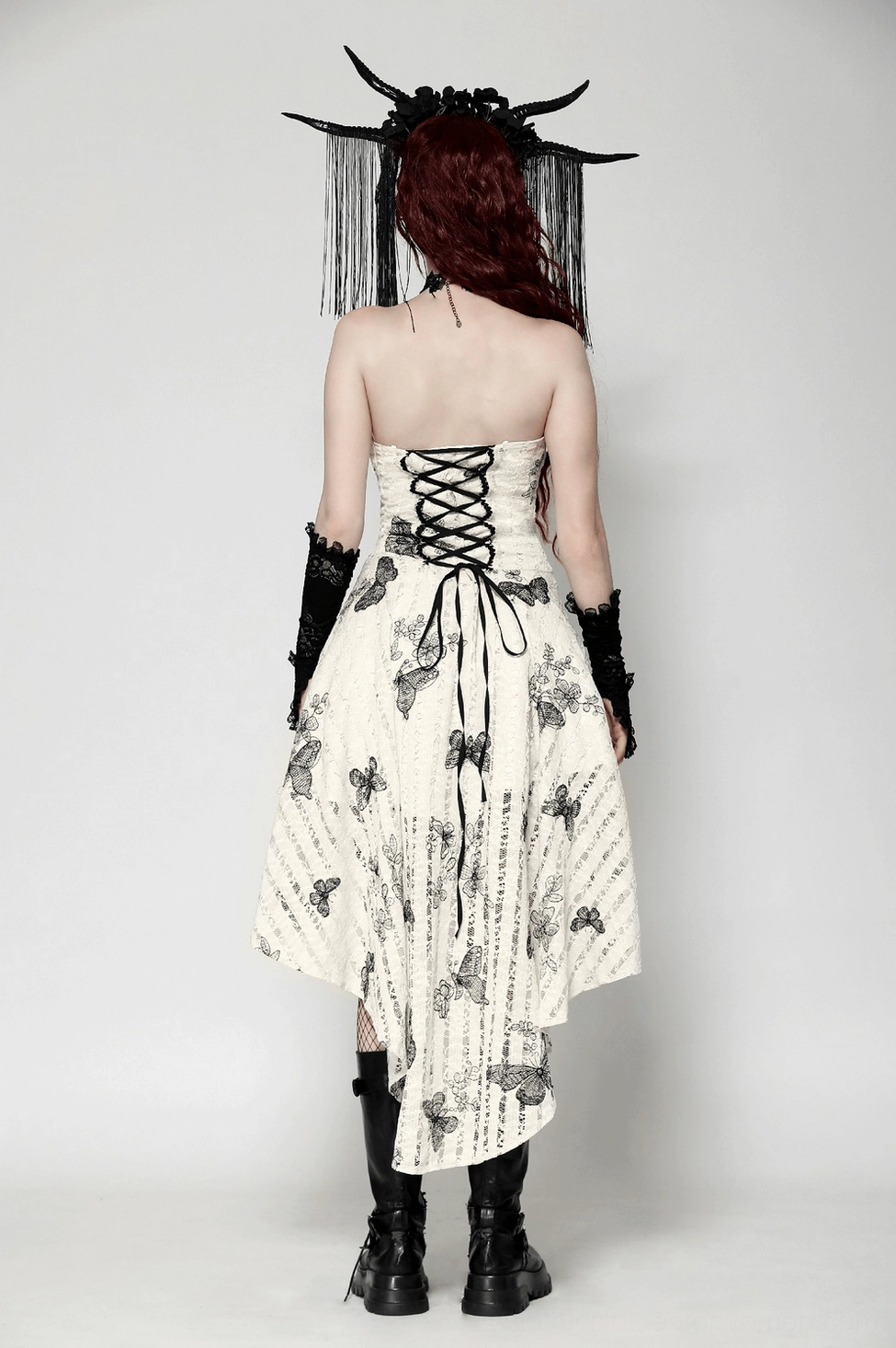 Side view of gothic butterfly dress displaying off-shoulder neckline, sleeve detail, and asymmetric high-low hemline construction