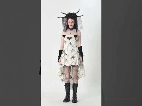 Gothic butterfly dress styled with fishnet stockings, black platform boots, gothic gloves and alternative accessories on model with dark background