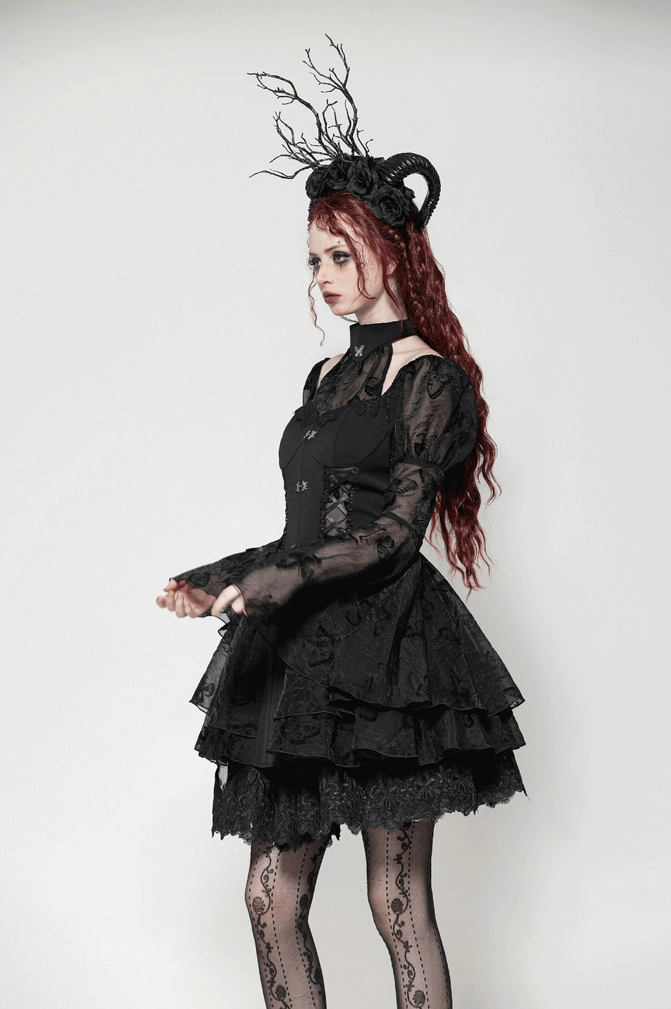 Black gothic butterfly mini dress detail showing waistline definition and structured corset construction