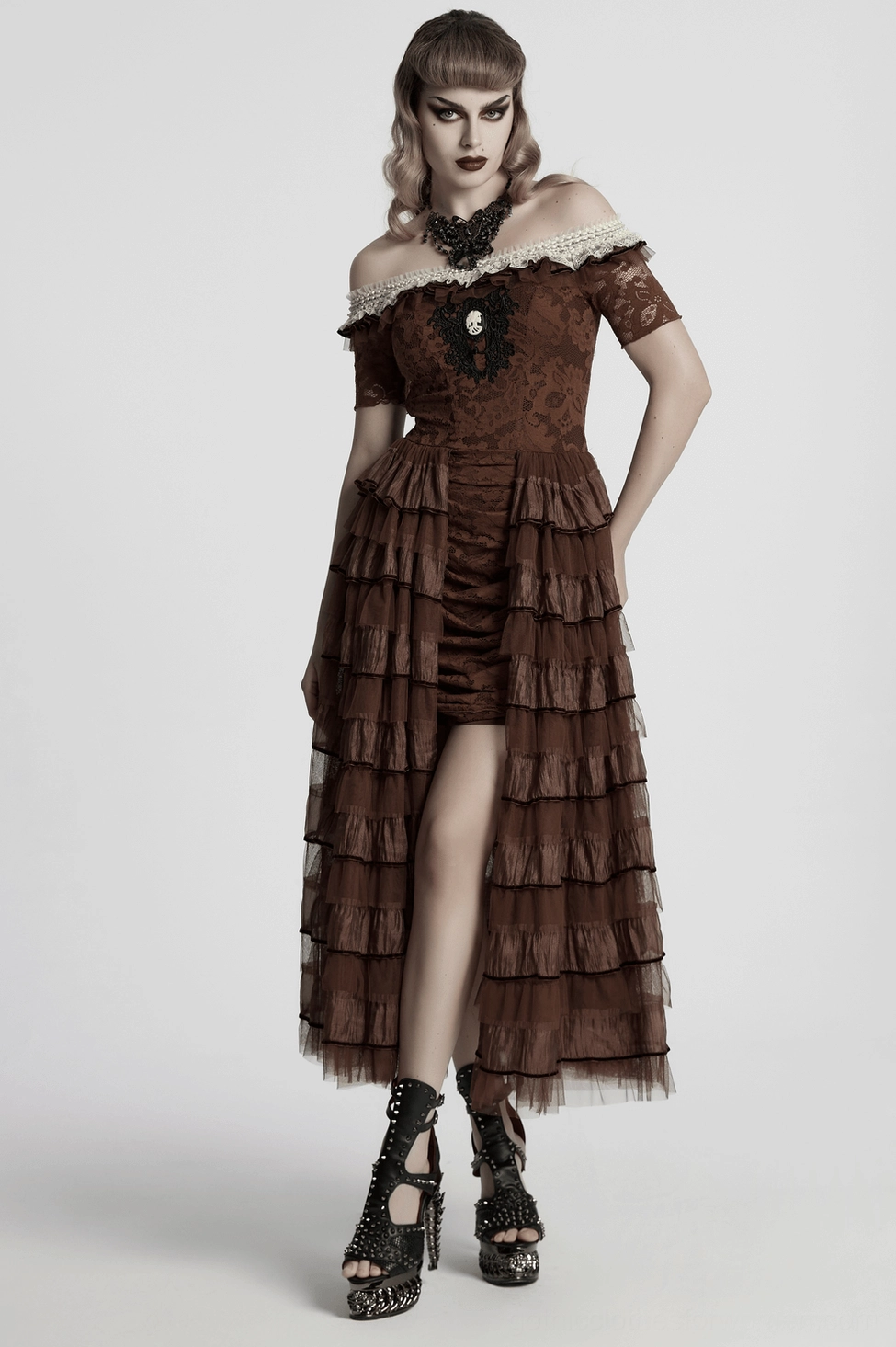 Full-body fashion showcase of gothic butterfly necklace worn with high-low ruffle brown dress and black platform heels