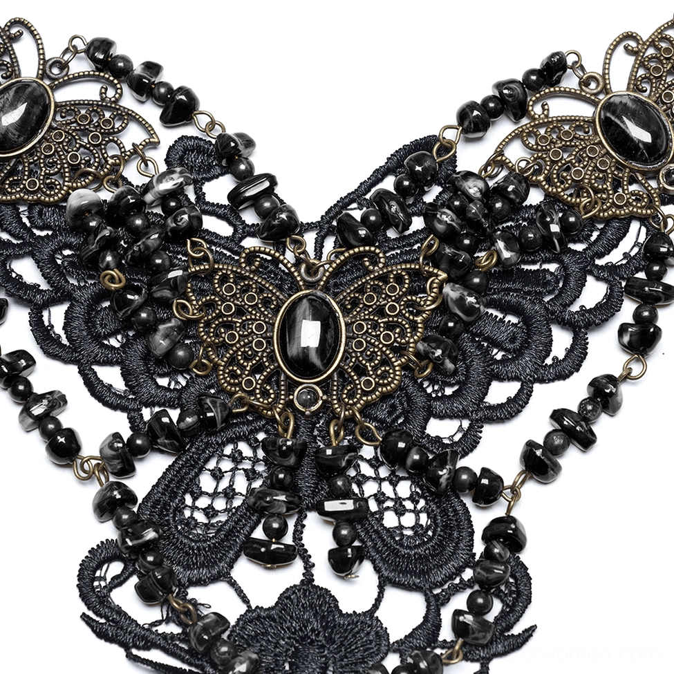 Close-up macro view of carved bronze butterfly pendant with oval black natural stone centerpiece