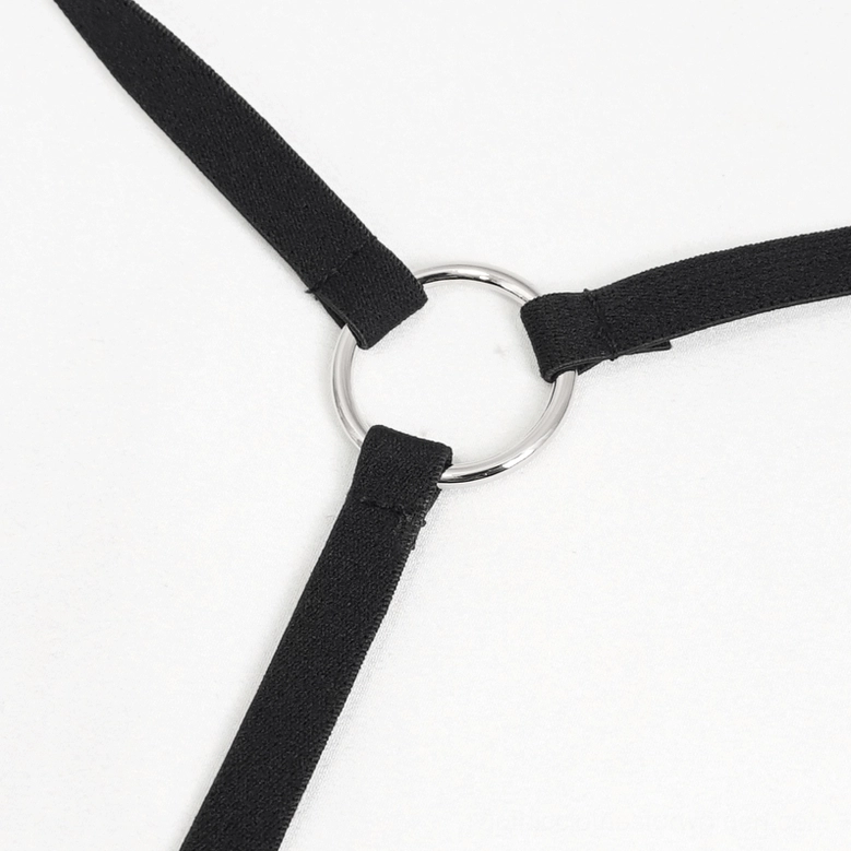 Close-up detail of metal O-ring hardware on back strap of black gothic cami top showing elastic construction