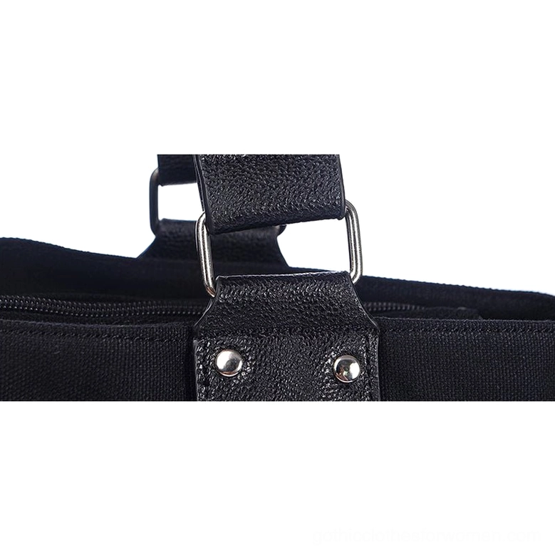 Close-up detail of black gothic tote bag handle hardware showing rivet-fixed leather handle straps