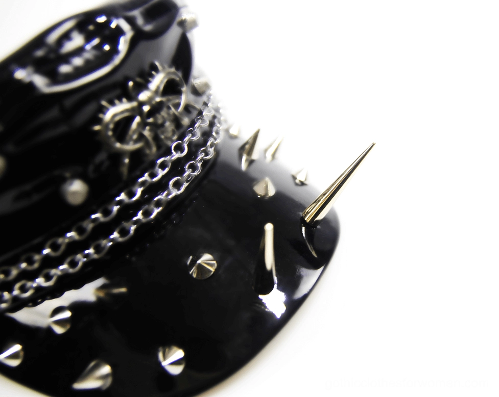 Layered metal chains and detailed spiked brim on gothic military cap - close-up front view