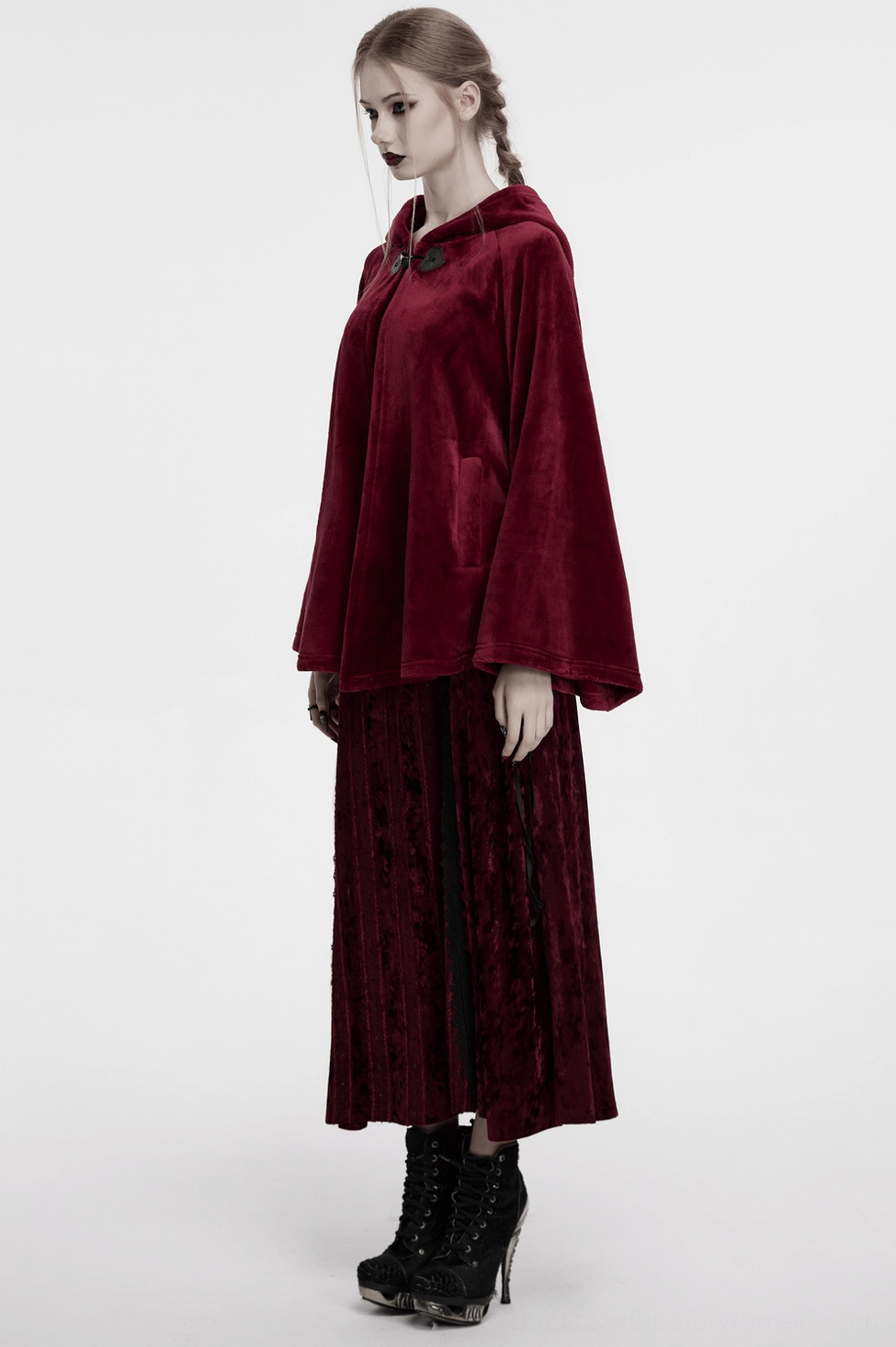 Full-length back view of burgundy velvet hooded cape on goth model, crescent moon embroidery focal point