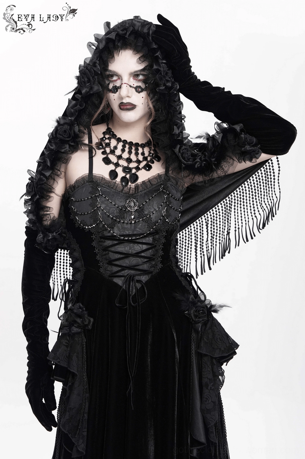 Black velvet hooded gothic cape with full beaded fringe hemline and rose floral hood detail on display mannequin