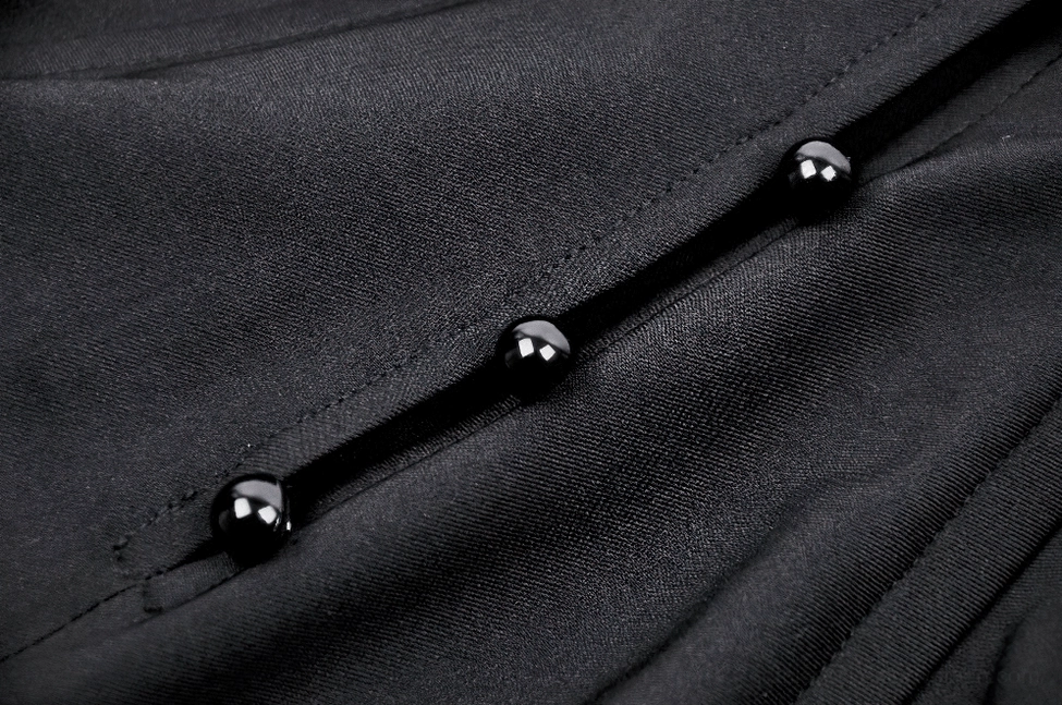 Close-up macro detail of black decorative buttons and smooth nylon fabric texture with neat stitched seams