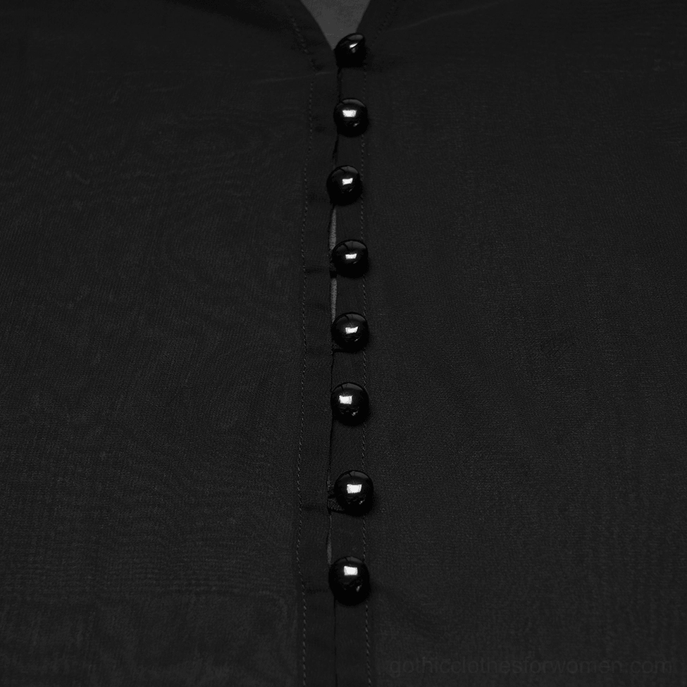 Close-up detail of black glossy button placket on sheer ombre chiffon gothic cape