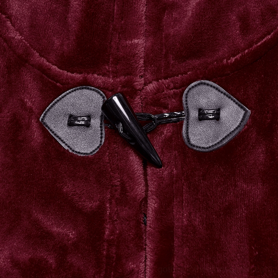 Extreme close-up of heart-shaped velvet toggle closure fasteners on burgundy gothic hooded cape