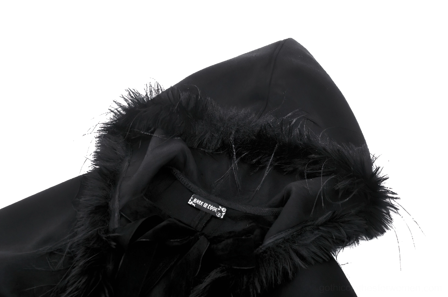 Close-up detail of gothic hooded cape interior showing faux fur lining and brand tag