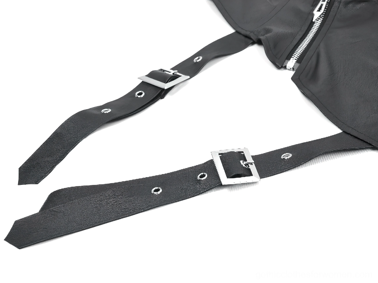 Flat lay product shot of black leather straps, metal buckles, and grommet holes on gothic punk cape hardware