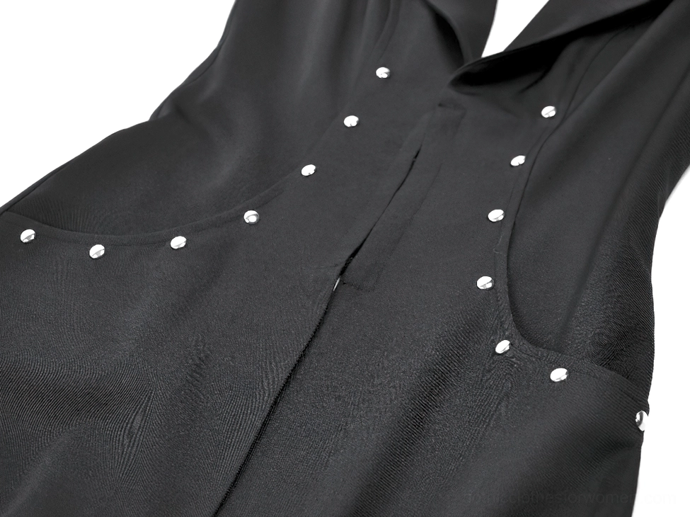 Stud embellishment close-up - round silver metallic studs on woven black fabric of gothic cape