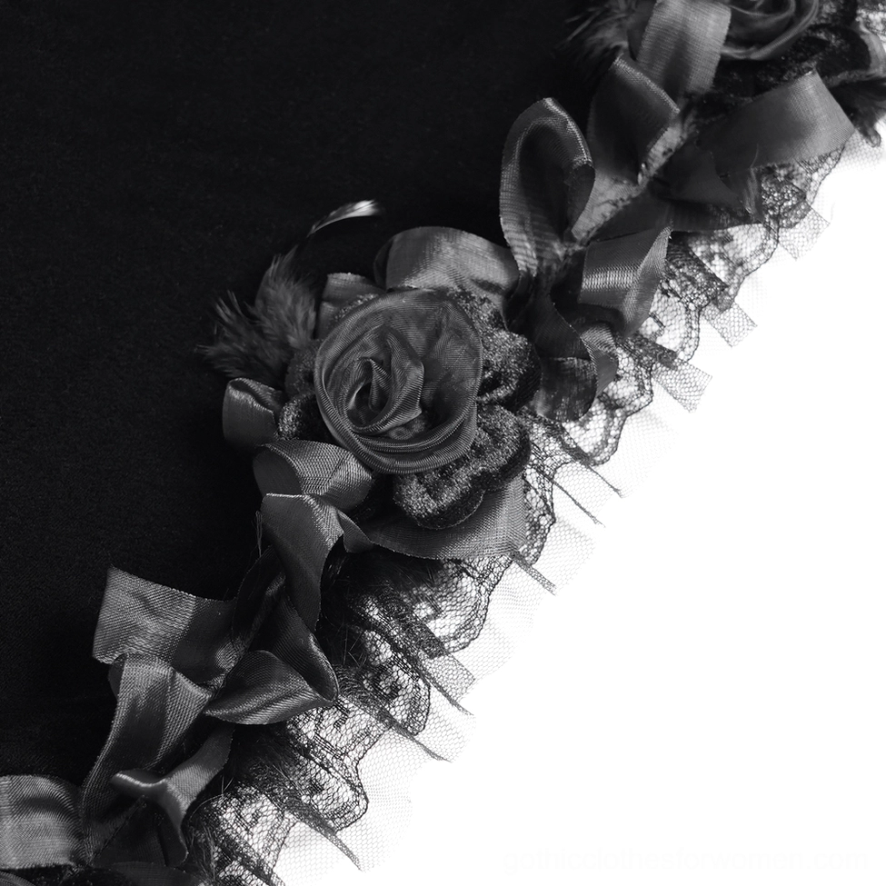 Macro close-up detail of cape decorative trim showing satin rose flowers and delicate lace ruffled edging on hood