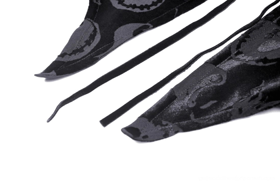 Black velvet gothic hooded cape detail shot, skull embossed pattern close-up, fabric drape and texture quality