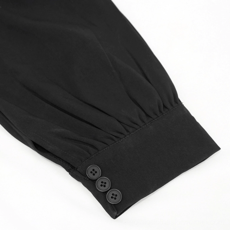 Close-up detail of gothic pants cuff showing multi-button closure gathered hem matte woven black fabric texture and hem construction