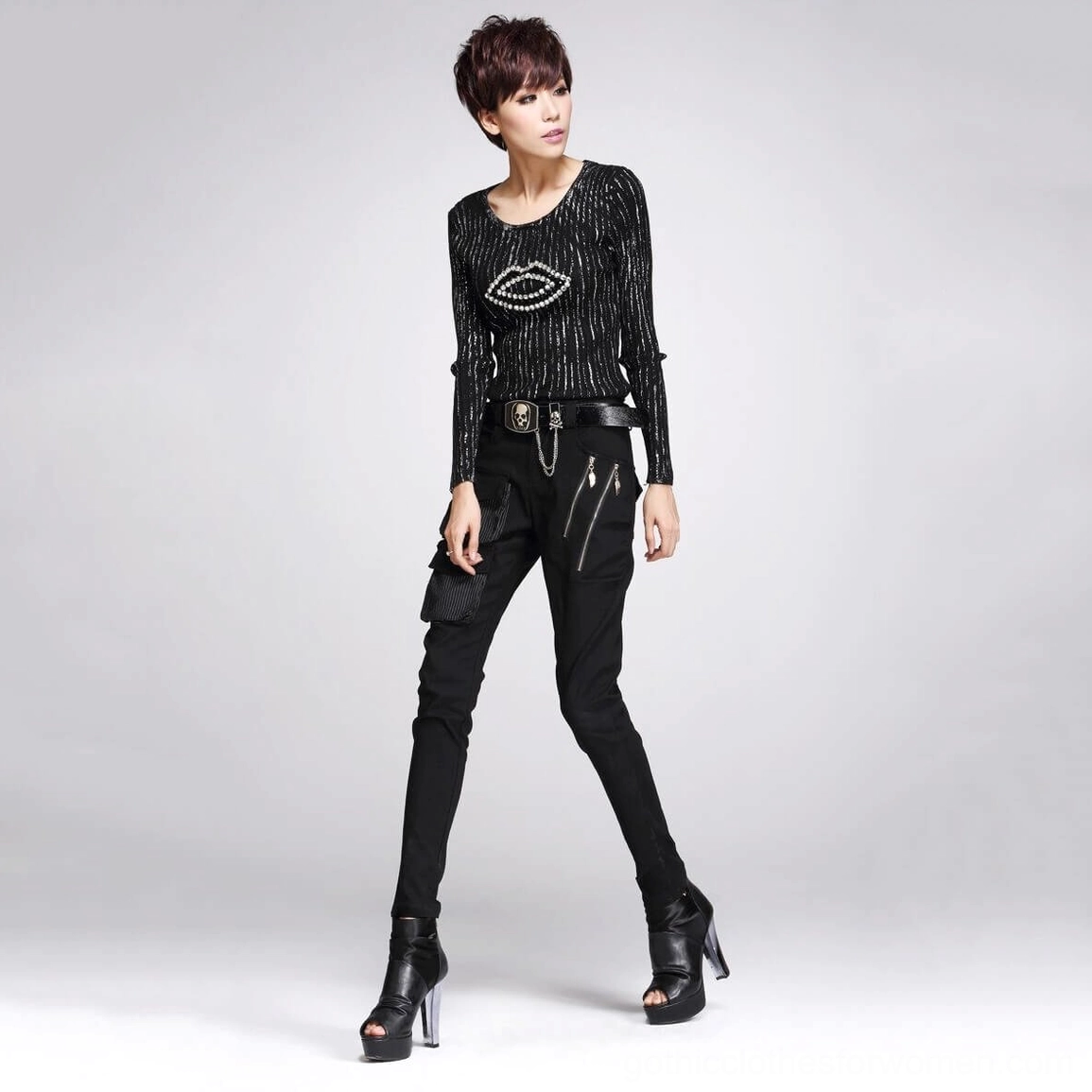 Black gothic cargo pants with graphic knit top front three-quarter pose showing decorative zipper details