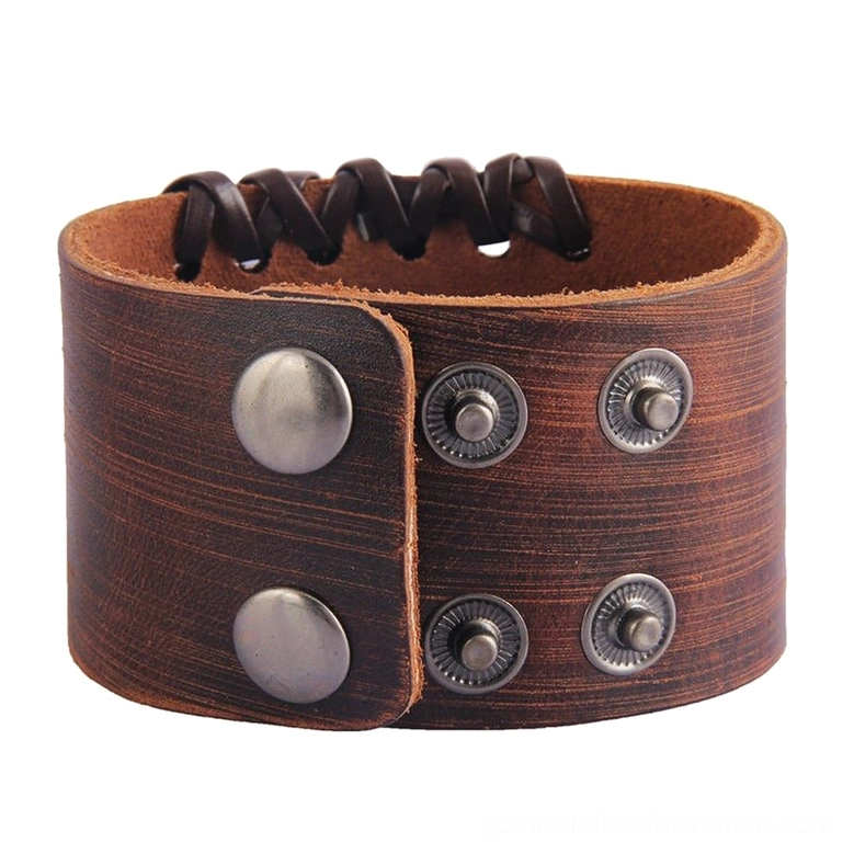 Black and brown leather cuff bracelets with Celtic cross - size measurement demonstration showing full bracelet length