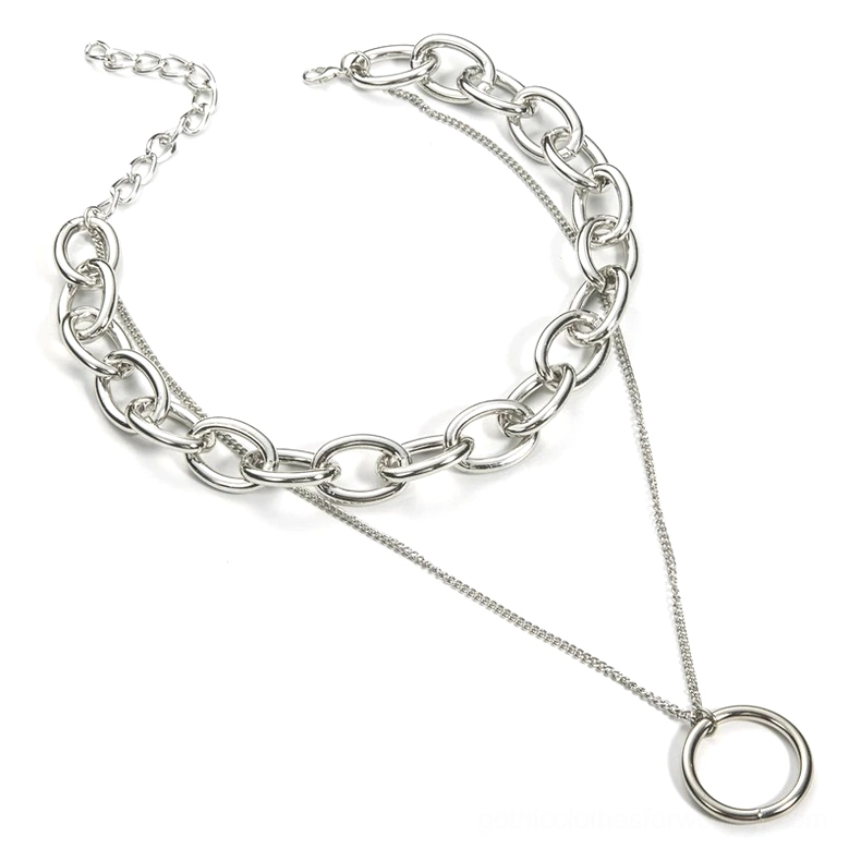Top-down flat lay view of layered gothic chain choker featuring thick curb chain and thin delicate chain with round pendant