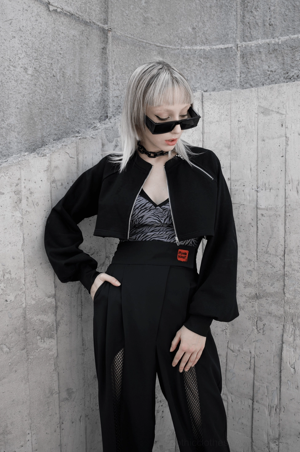 Gothic chain crop jacket worn by model in styled composition showcasing alternative fashion aesthetic