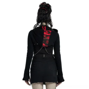 Black gothic cropped knit top back view showing cross-body chain harness and D-ring details with fishnet tights on model
