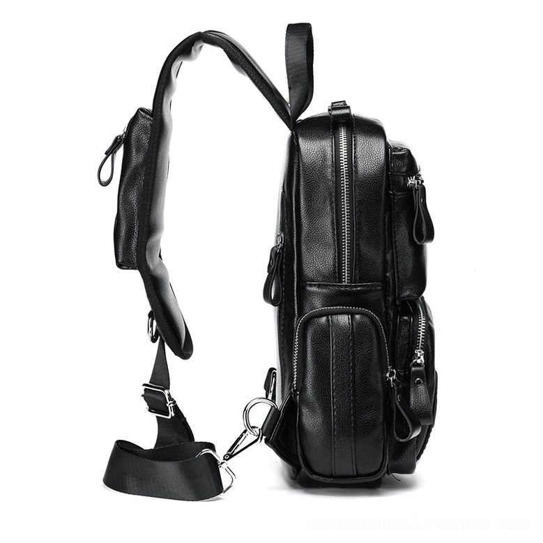 Side profile view of black gothic chest bag showing adjustable padded strap and metal hardware