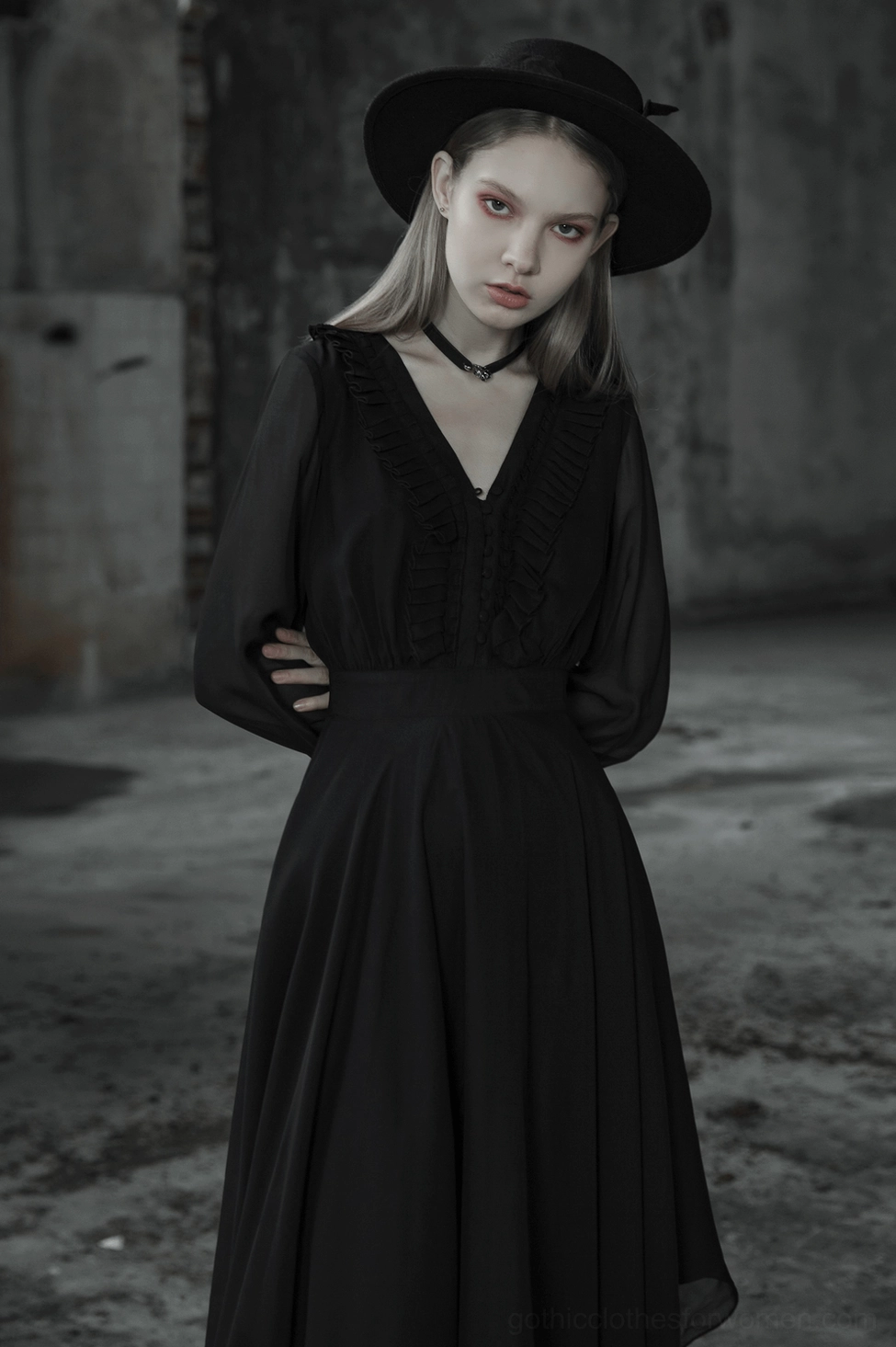 Black asymmetrical chiffon gothic dress front detail on mannequin showing buttoned closure and ruffled placket